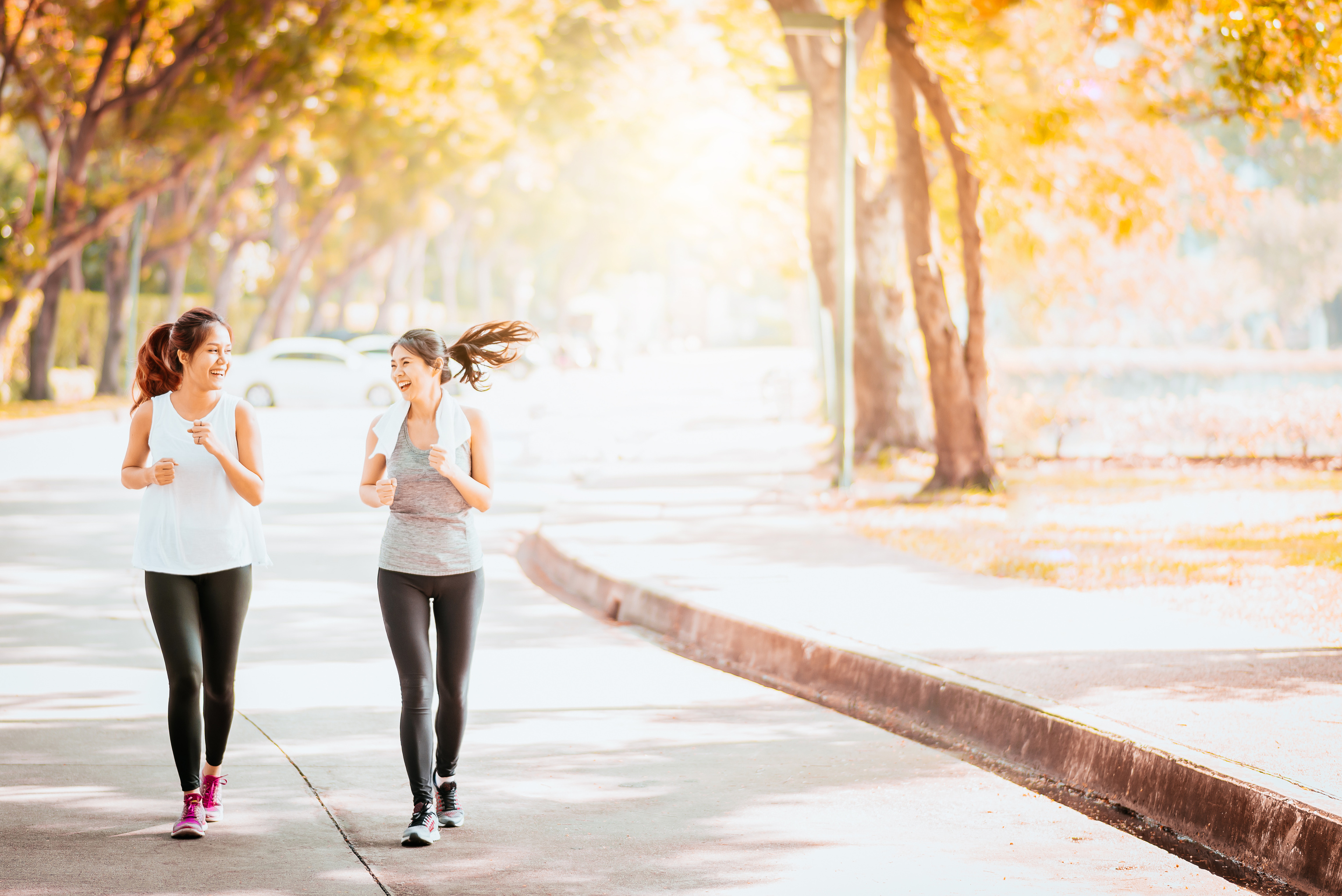 Female Friends Jogging Together in the Park 